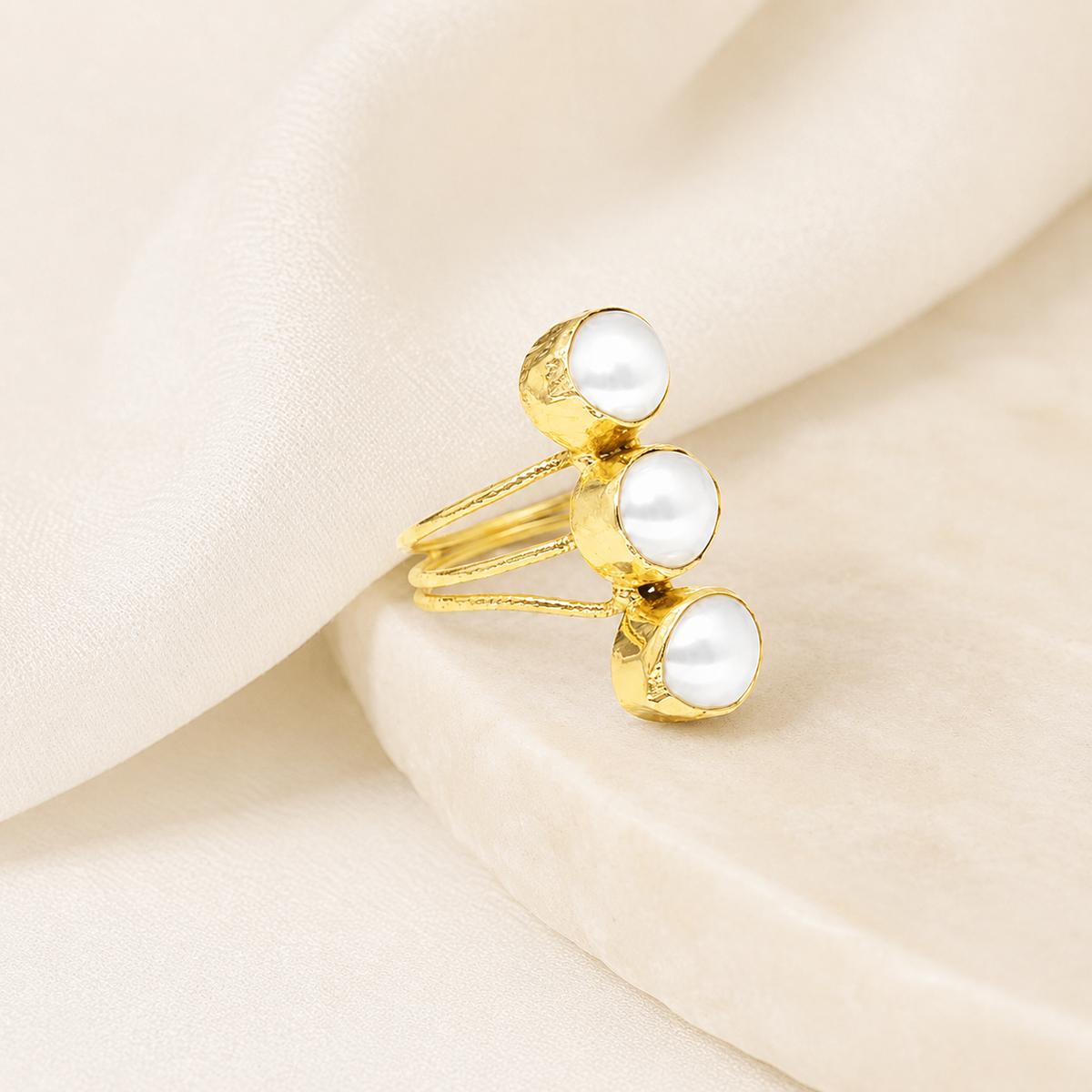 Triple pearl open wrap ring on a white background.