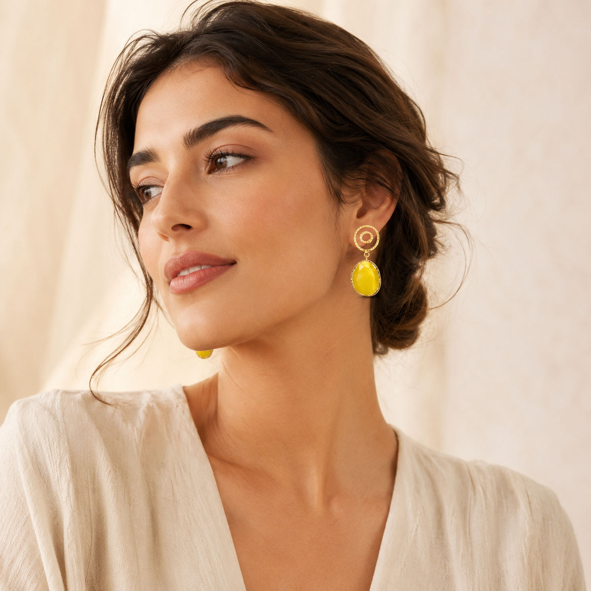 Yellow drop earrings with spiral gold-plated tops and faceted oval accents.