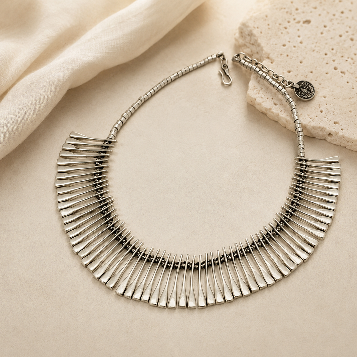 Silver-tone collar necklace with a wide fan silhouette.