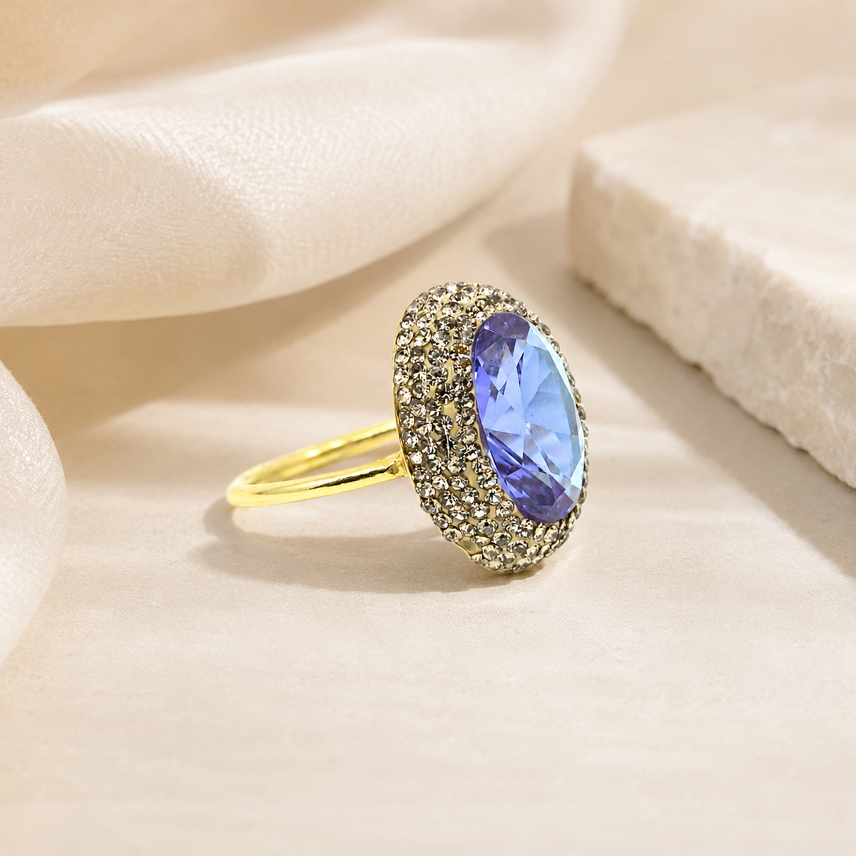 Gold-tone ring with a color-changing center and slim band on a white background.
