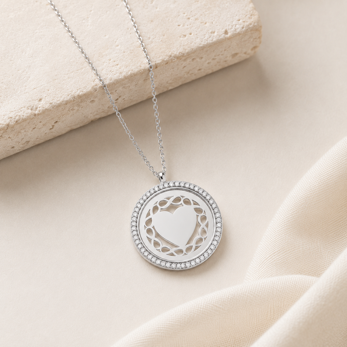 Silver-tone personalized necklace with a round pendant and openwork heart design.