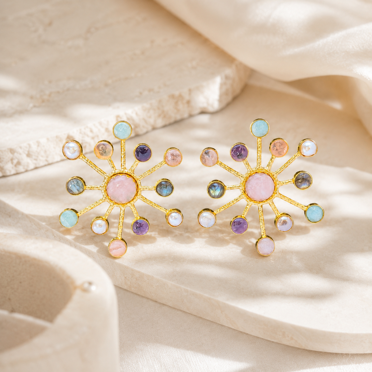 Pair of starburst statement earrings with multicolor gemstone-style accents and a gold-plated look.