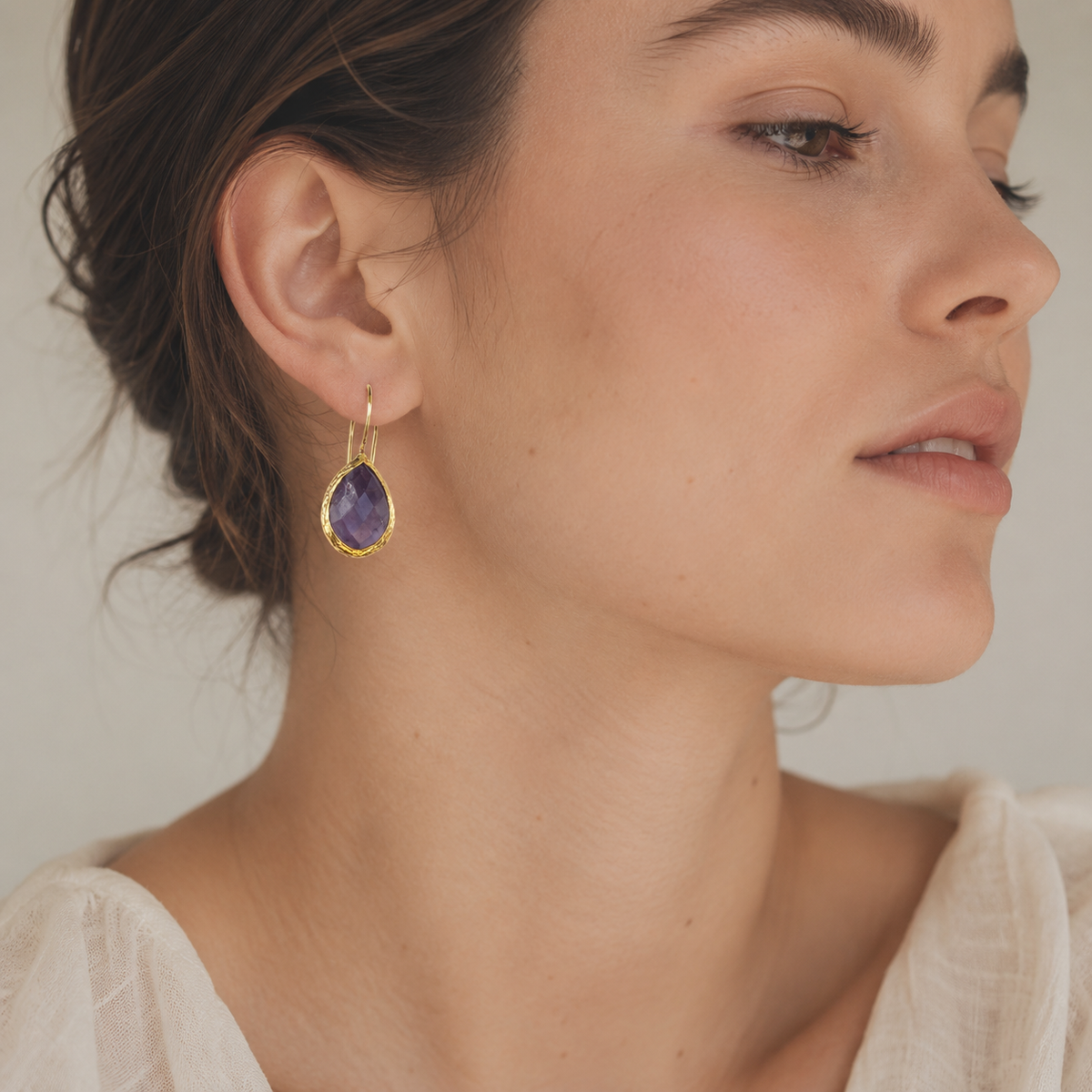Amethyst teardrop earrings shown front view with gold-plated hooks.