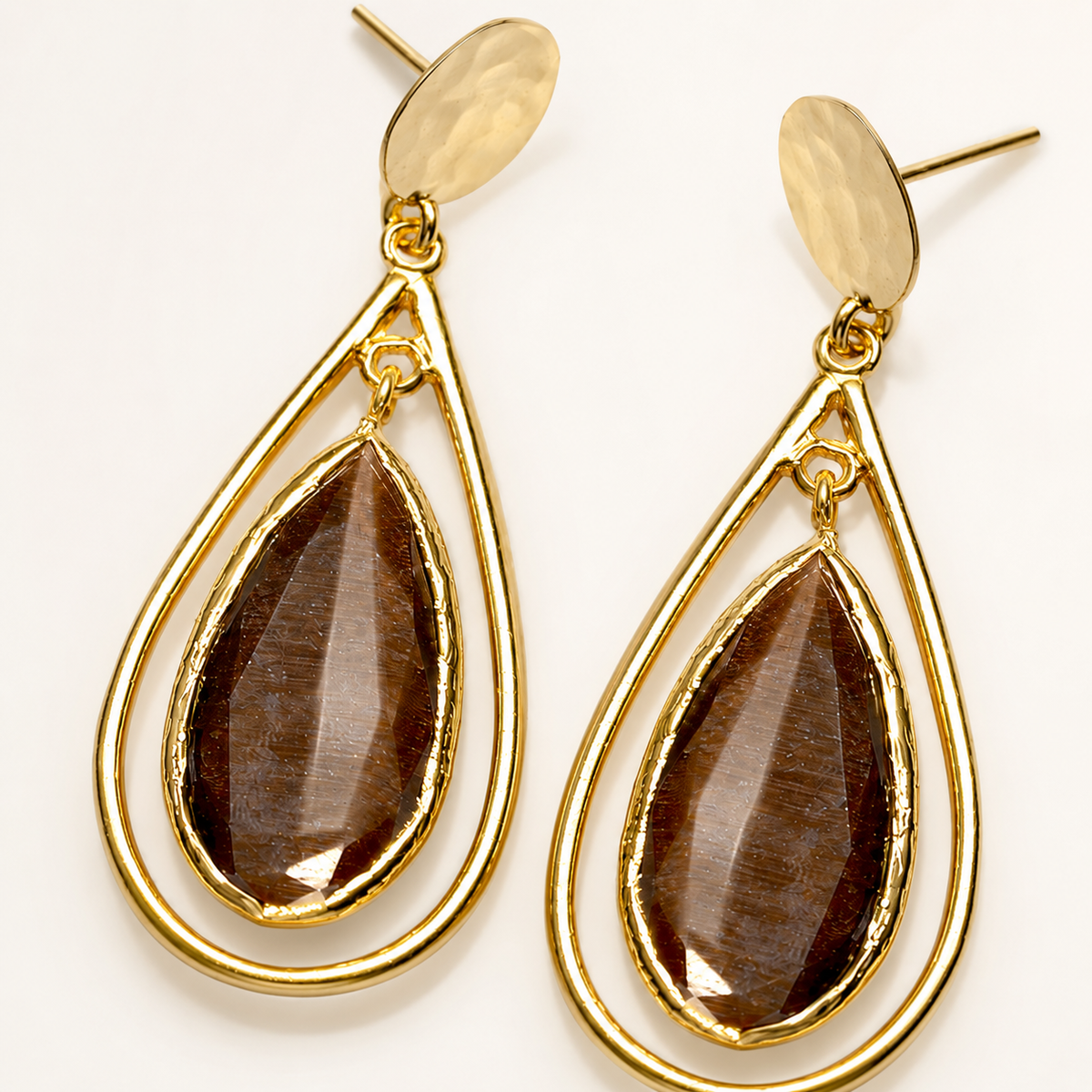 Brown teardrop drop earrings with a gold-plated cage silhouette.