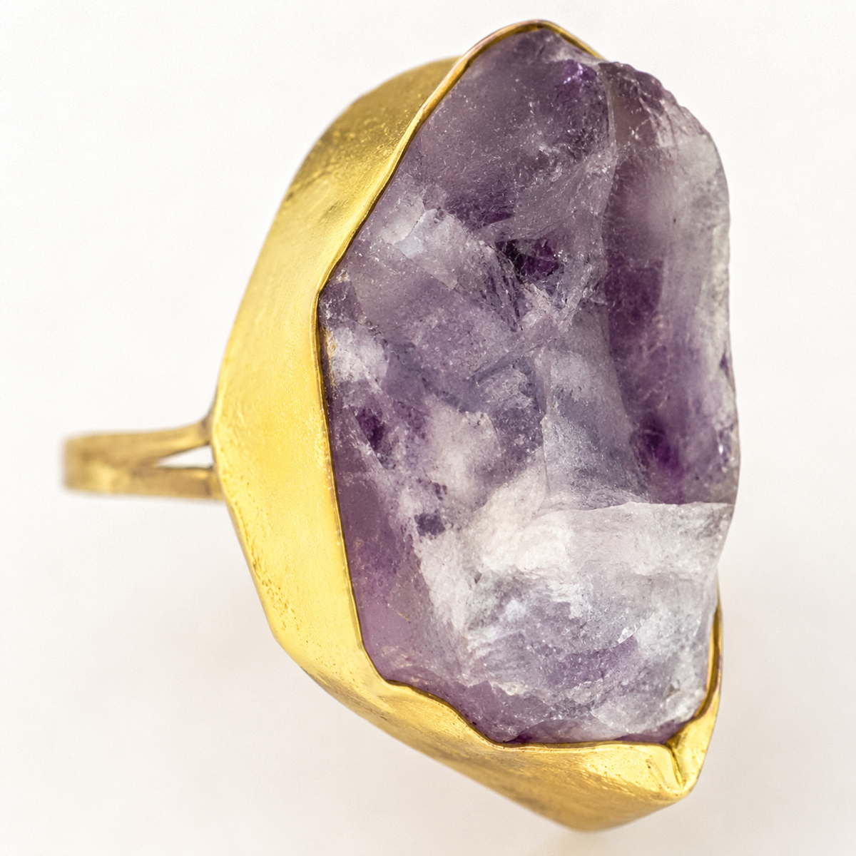 Close view of the raw purple amethyst and gold-plated ring setting.