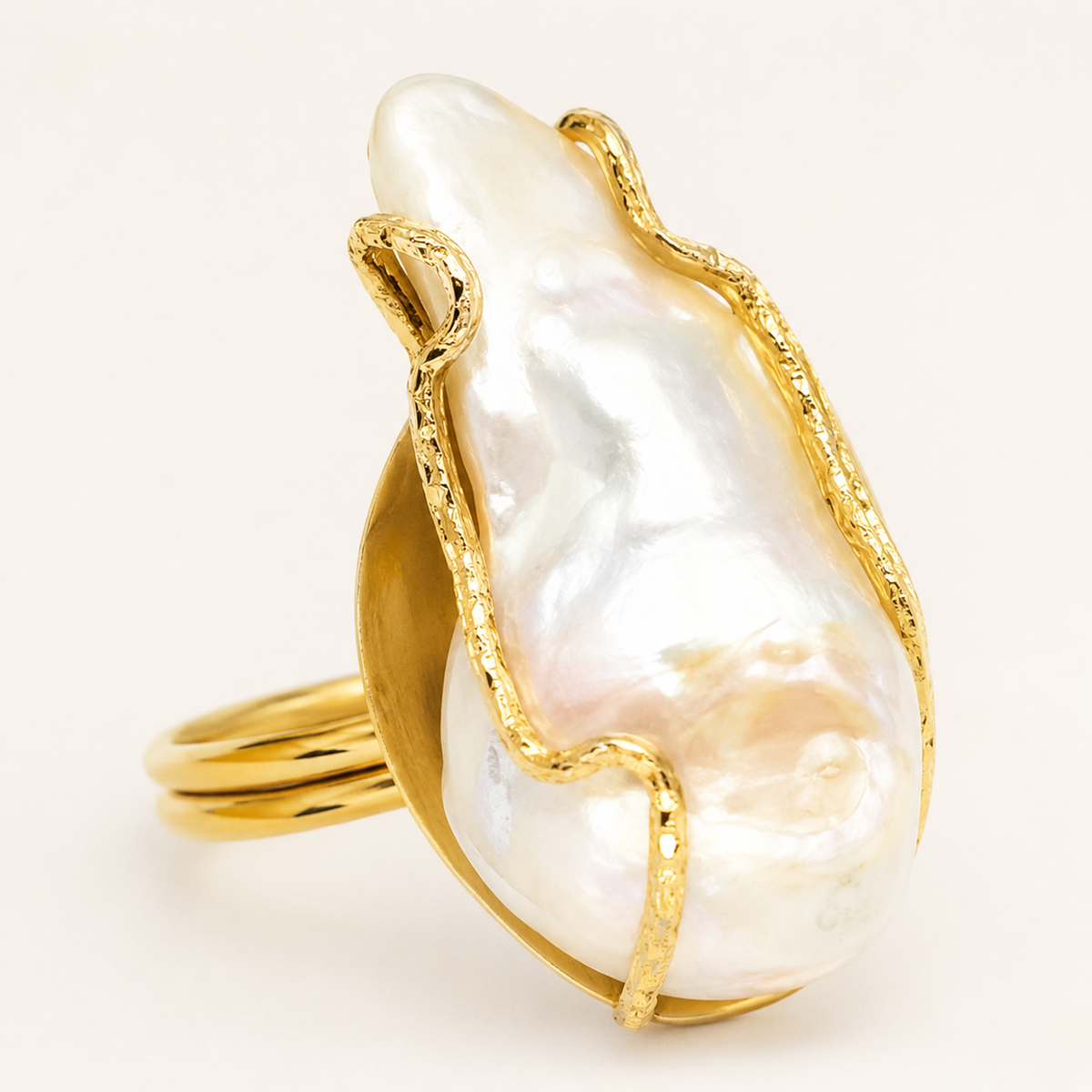 Close view of the baroque pearl and gold-plated ring setting.