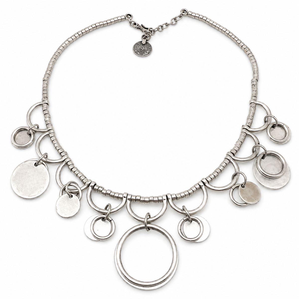 Silver-tone collar necklace with ring charms and an open circle pendant.