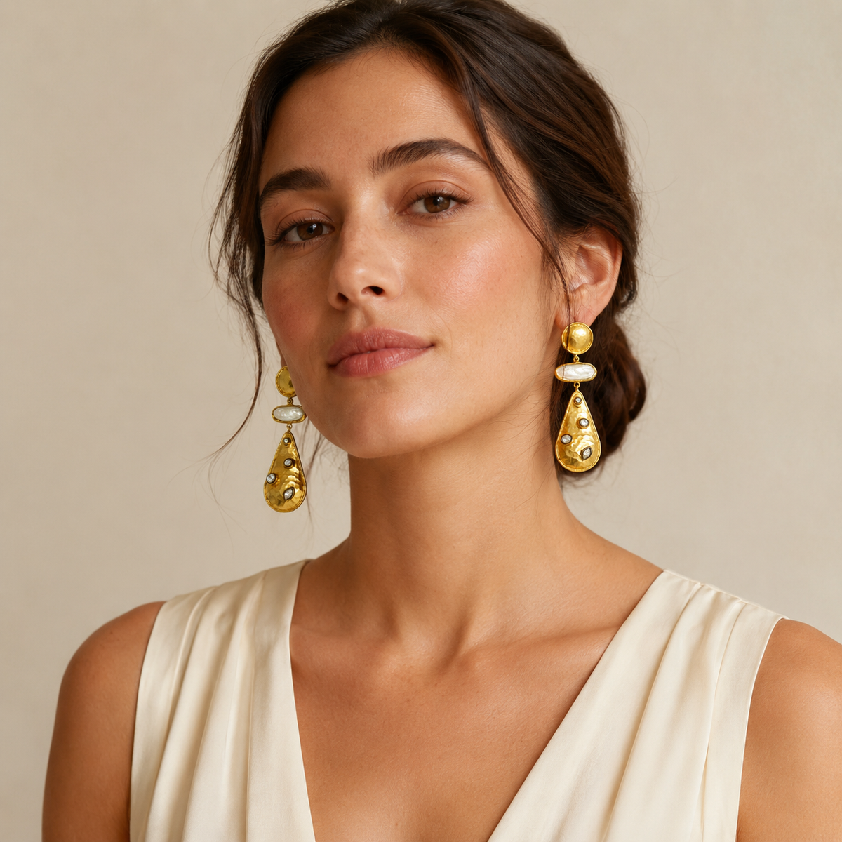 Statement earrings with a polished gold finish and stone accents.