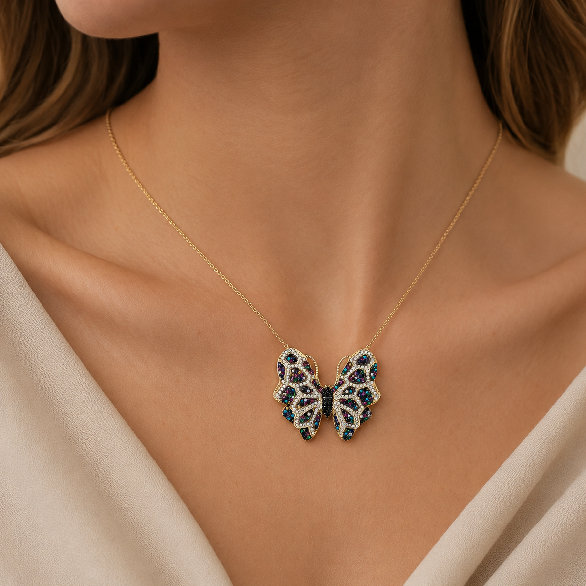 Gold-tone butterfly necklace with multicolor CZ accents shown front view.