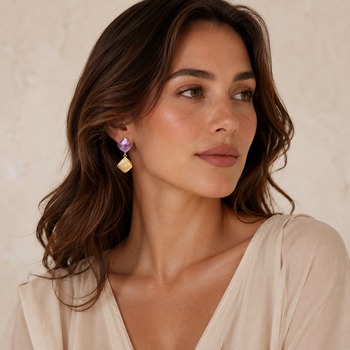 Pair of statement drop earrings with faceted purple and yellow stones.