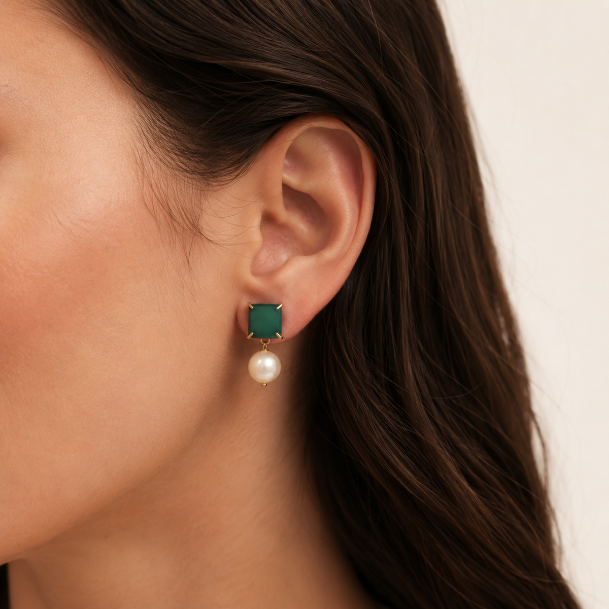 Pair of green chalcedony and pearl drop earrings shown on a white background.