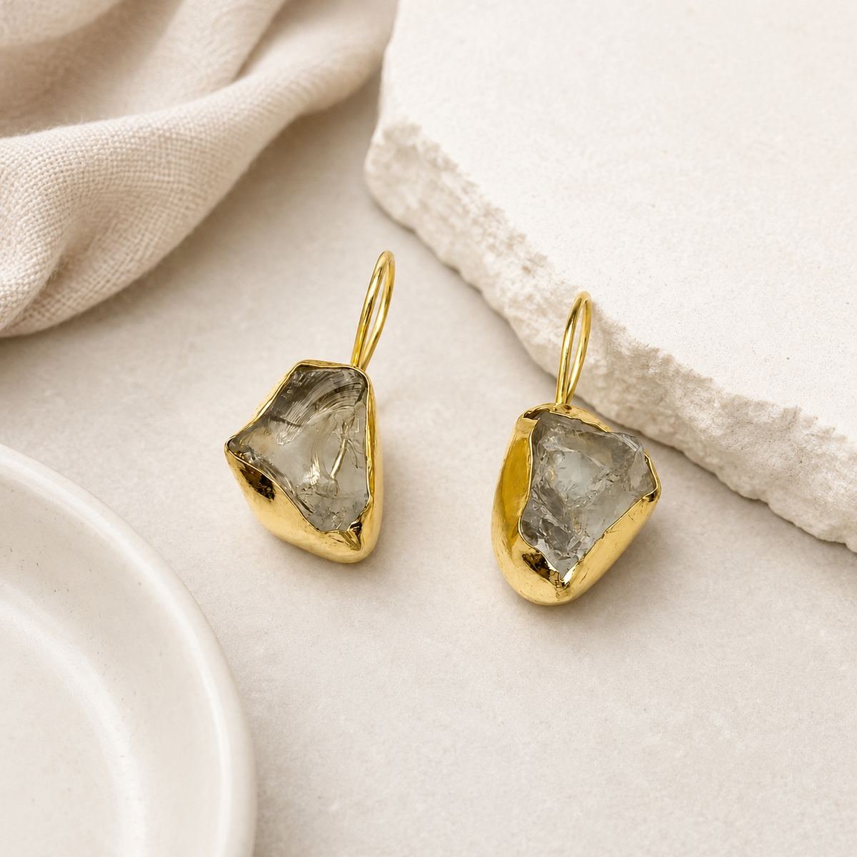 Gold-plated raw amethyst drop earrings with an organic sculptural shape.