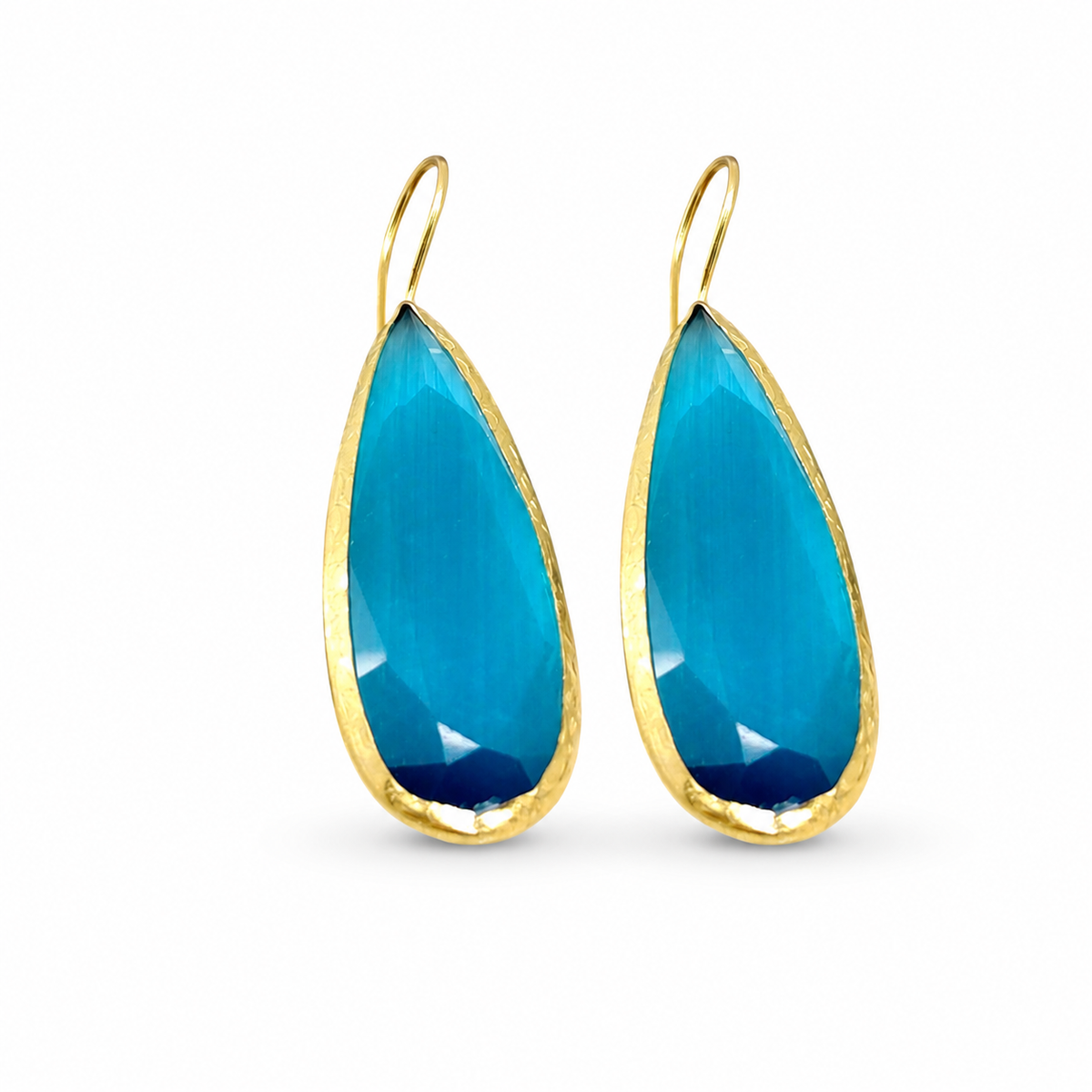 Pair of ocean blue teardrop earrings with gold-plated brass framing.