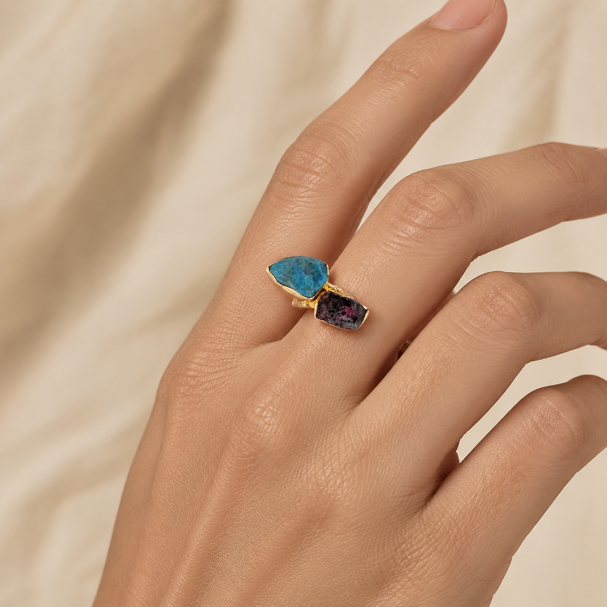 Raw apatite and garnet two stone ring shown on a model.