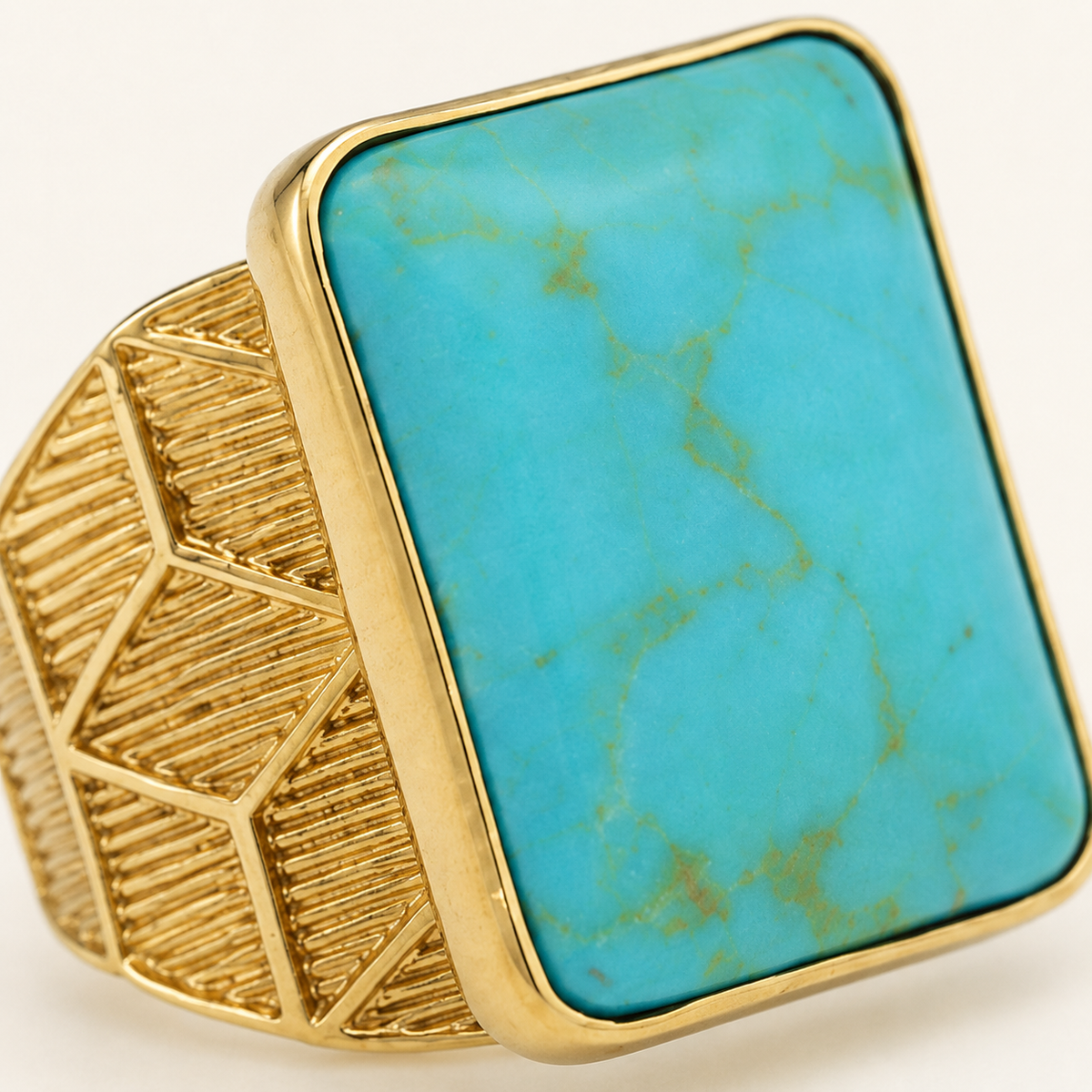 Close view of the square turquoise stone and gold-plated frame.