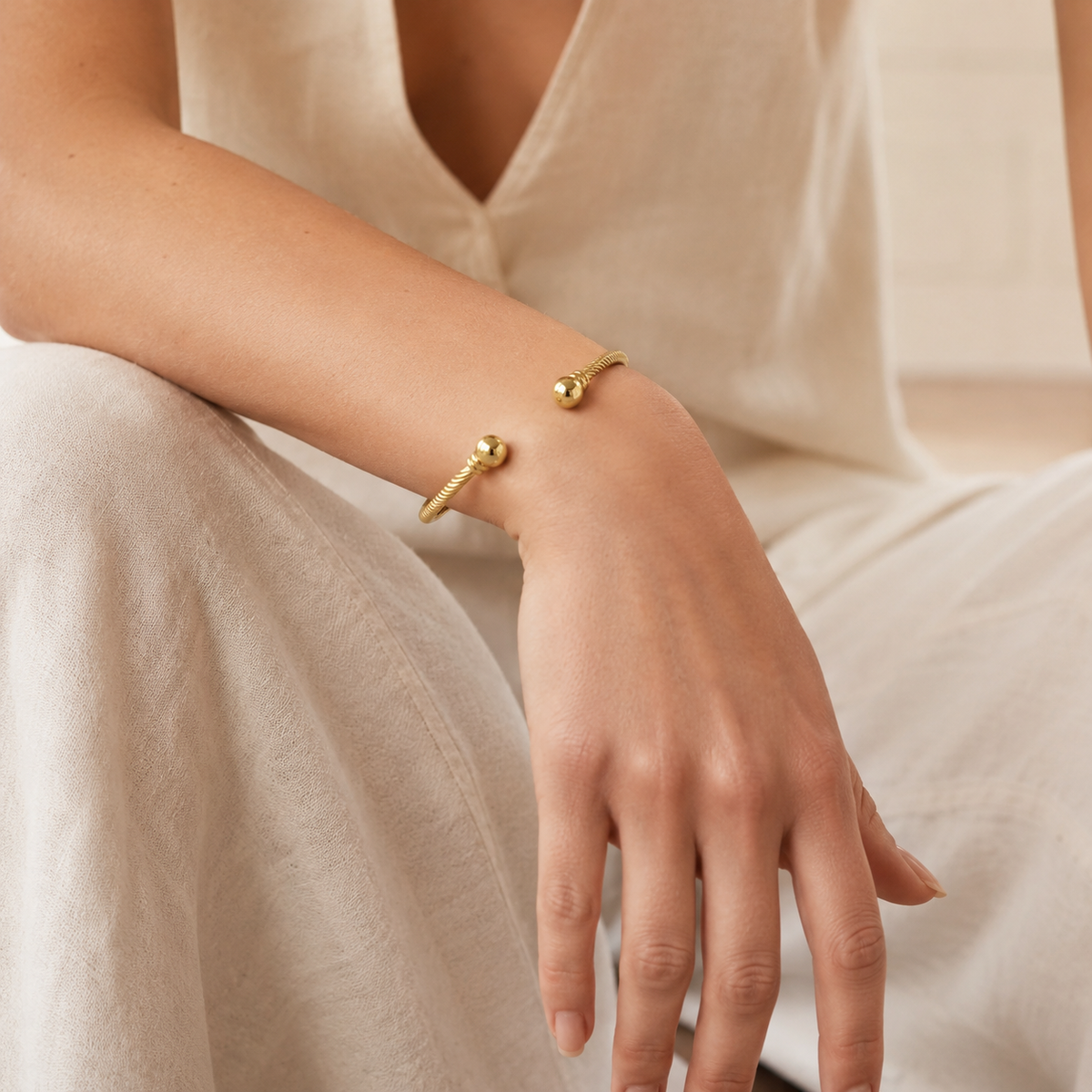 Gold-tone open cuff bracelet with twisted detailing.
