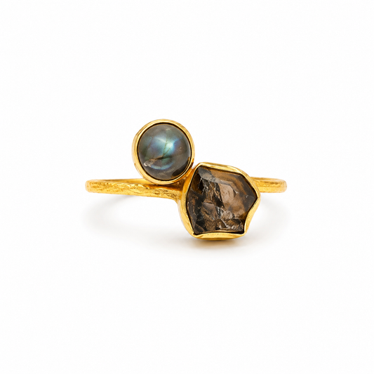 Gold-plated ring with labradorite and smoky quartz stones on a white background.
