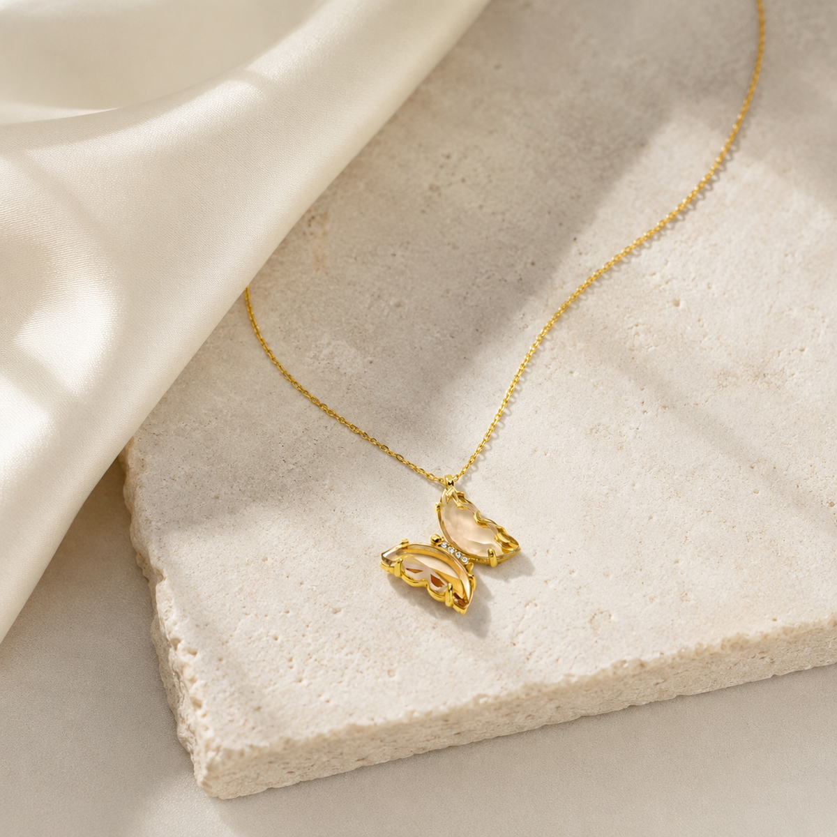 Gold plated butterfly necklace styled for a soft, feminine look.