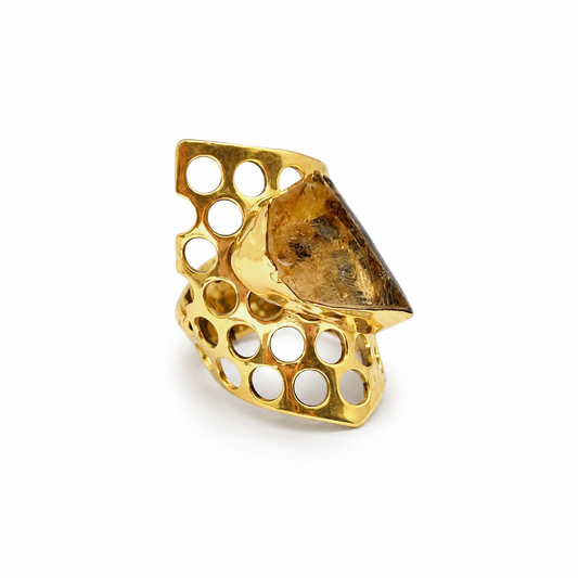 Gold-plated statement ring with a rough citrine center and honeycomb openwork design.