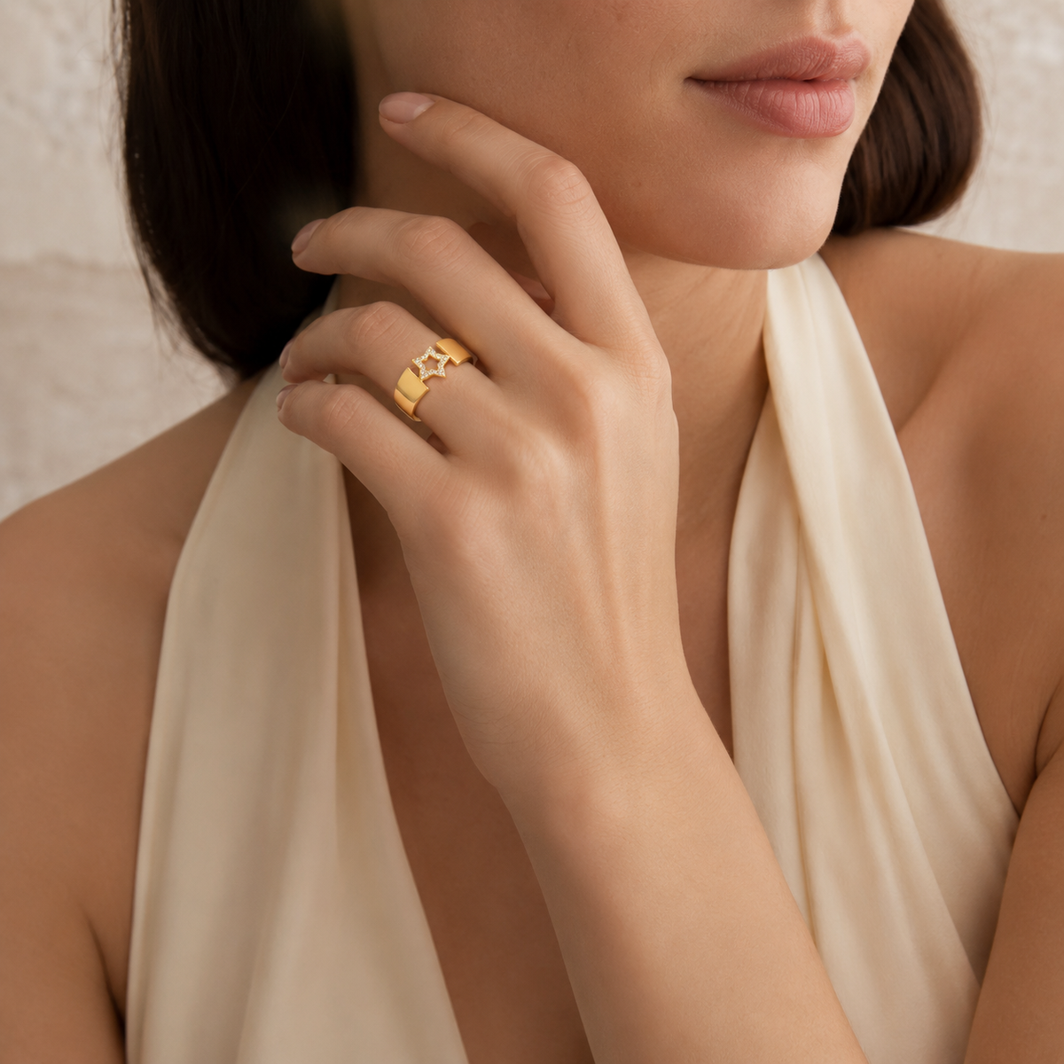 Front view of a gold-plated ring with a CZ star design.