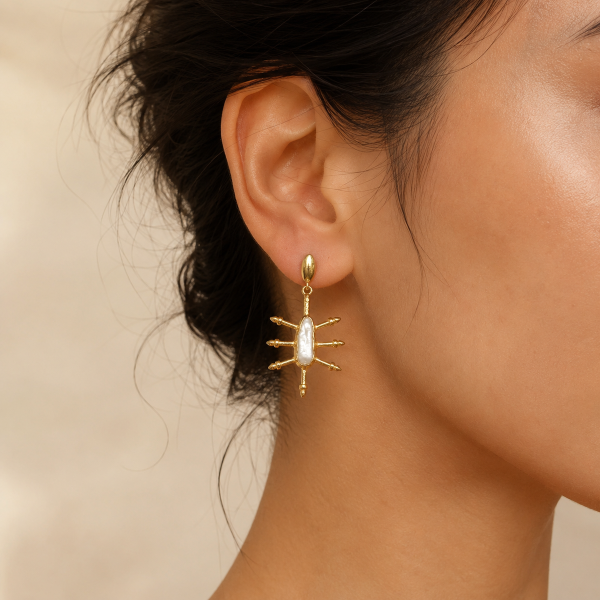 Pair of gold-plated drop earrings with a cushion-shaped blue sapphire look shown on a white background.