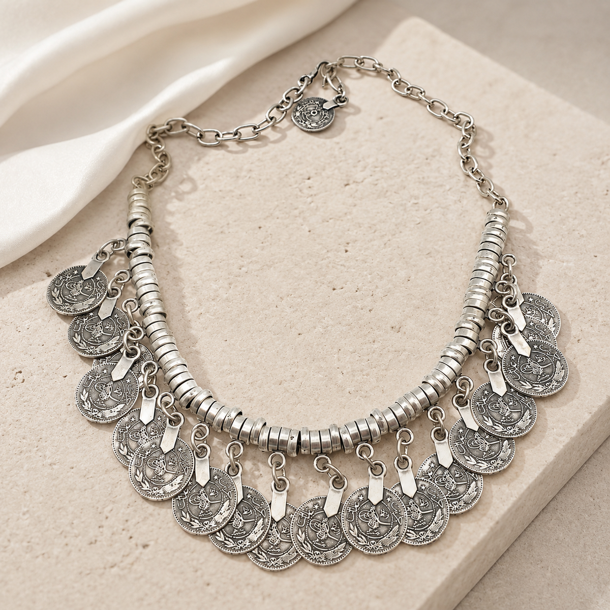 Silver-tone fringe necklace with a layered disc design.