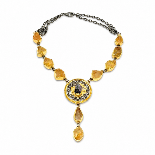 Citrine medallion drop necklace worn on the neck with golden stones and a detailed center pendant.