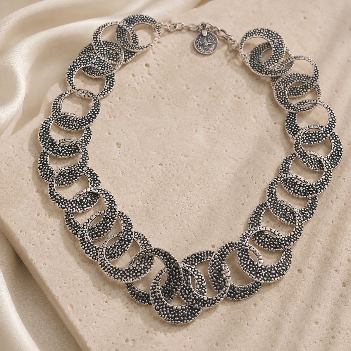 Textured silver oval link necklace with interlocking links.