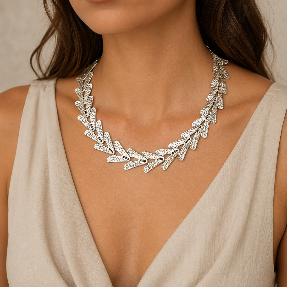 Model wearing a silver-tone arrow link collar necklace.