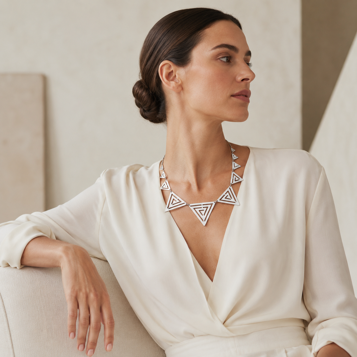 Statement necklace with bold triangle shapes and a silver-tone finish.