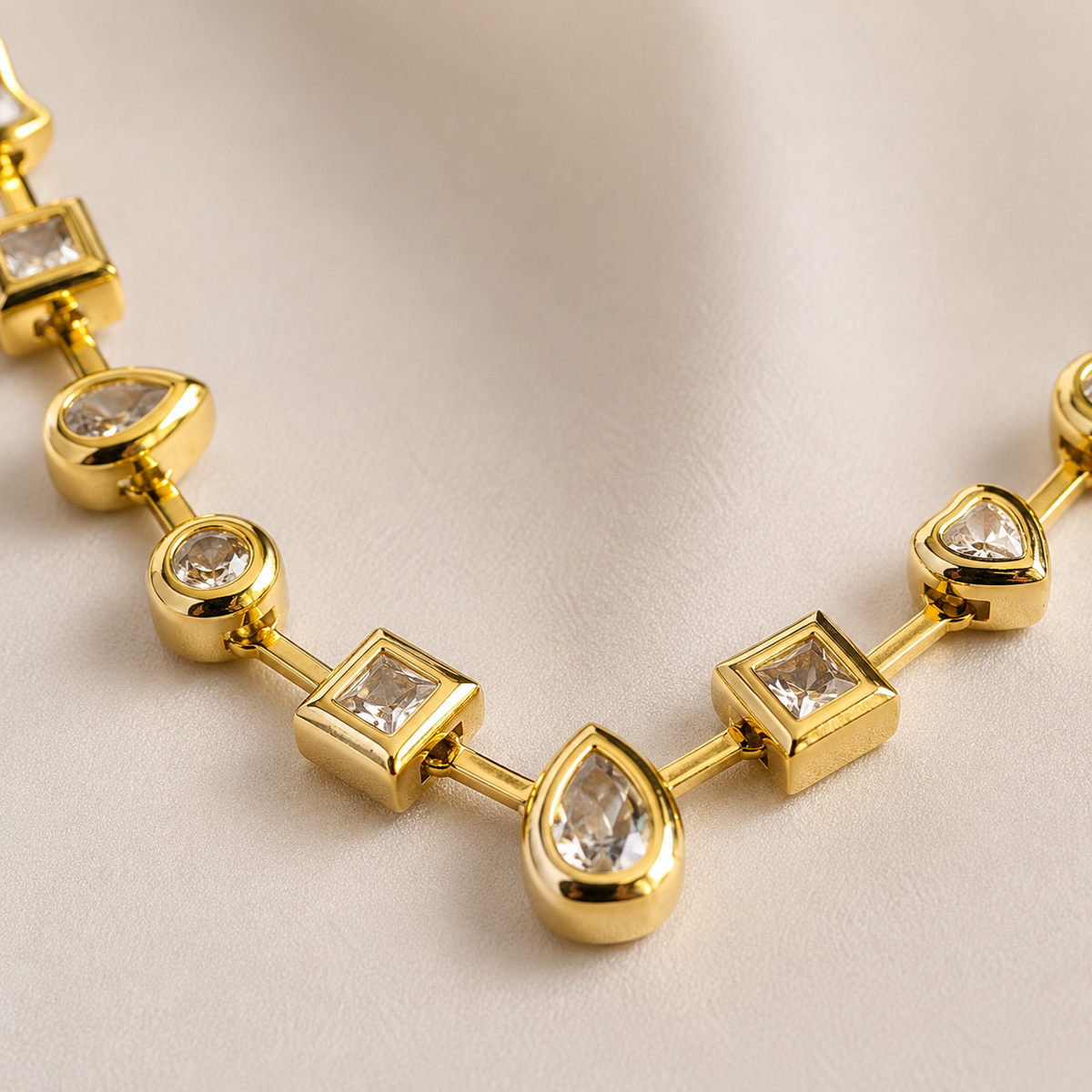 Close view of the mixed shape stone stations and gold-tone setting.