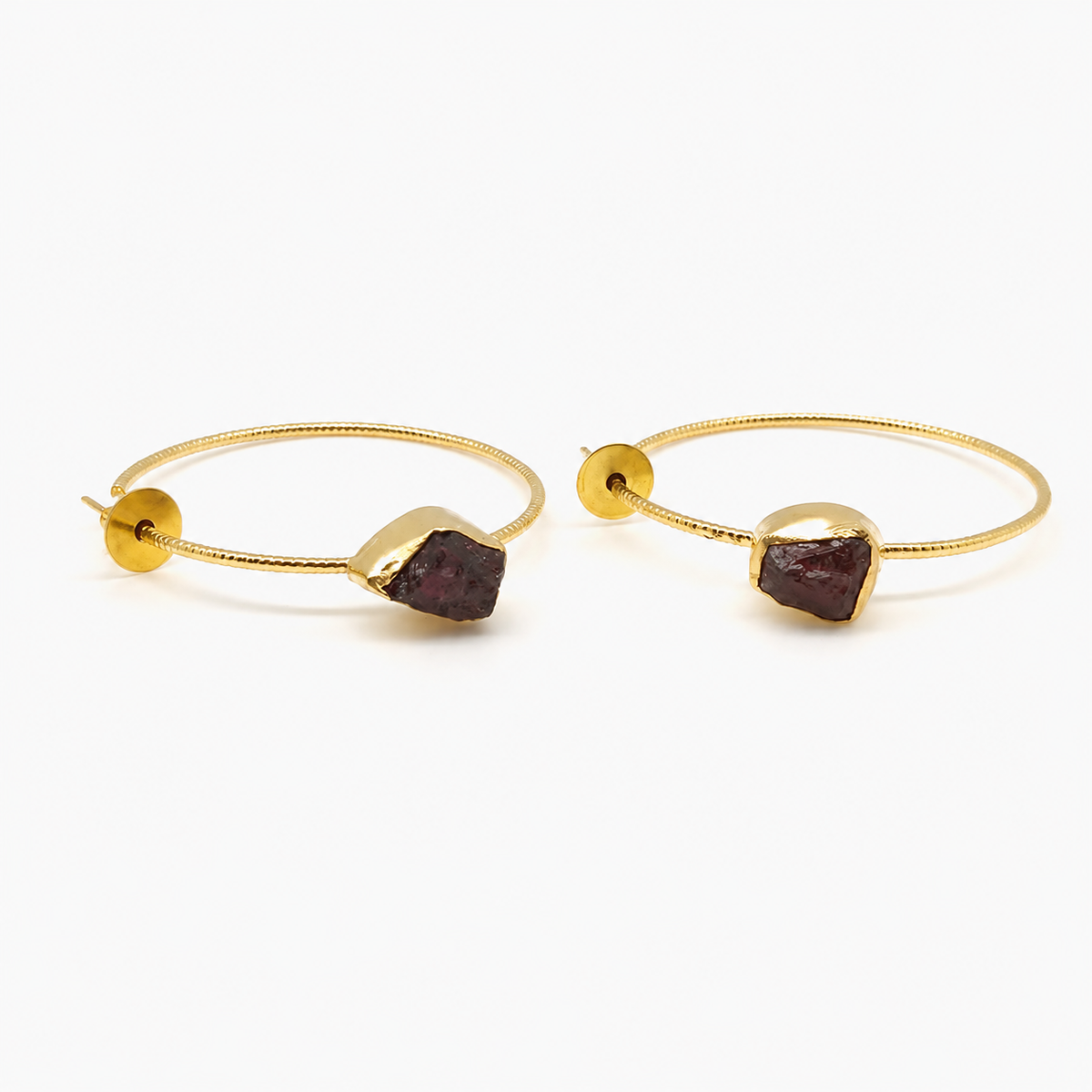 Gold-plated hook earrings with green agate slice stones on a white background.