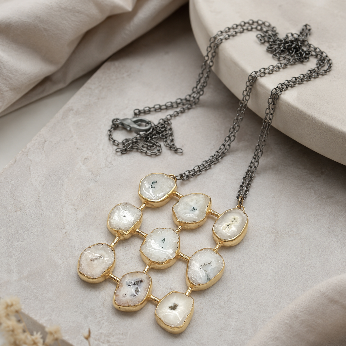Angle view of the quartz-like grid pendant necklace and chain.
