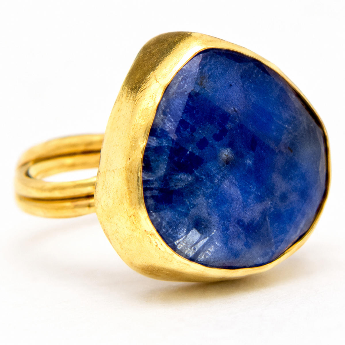 Close view of the lapis blue stone and polished gold setting.