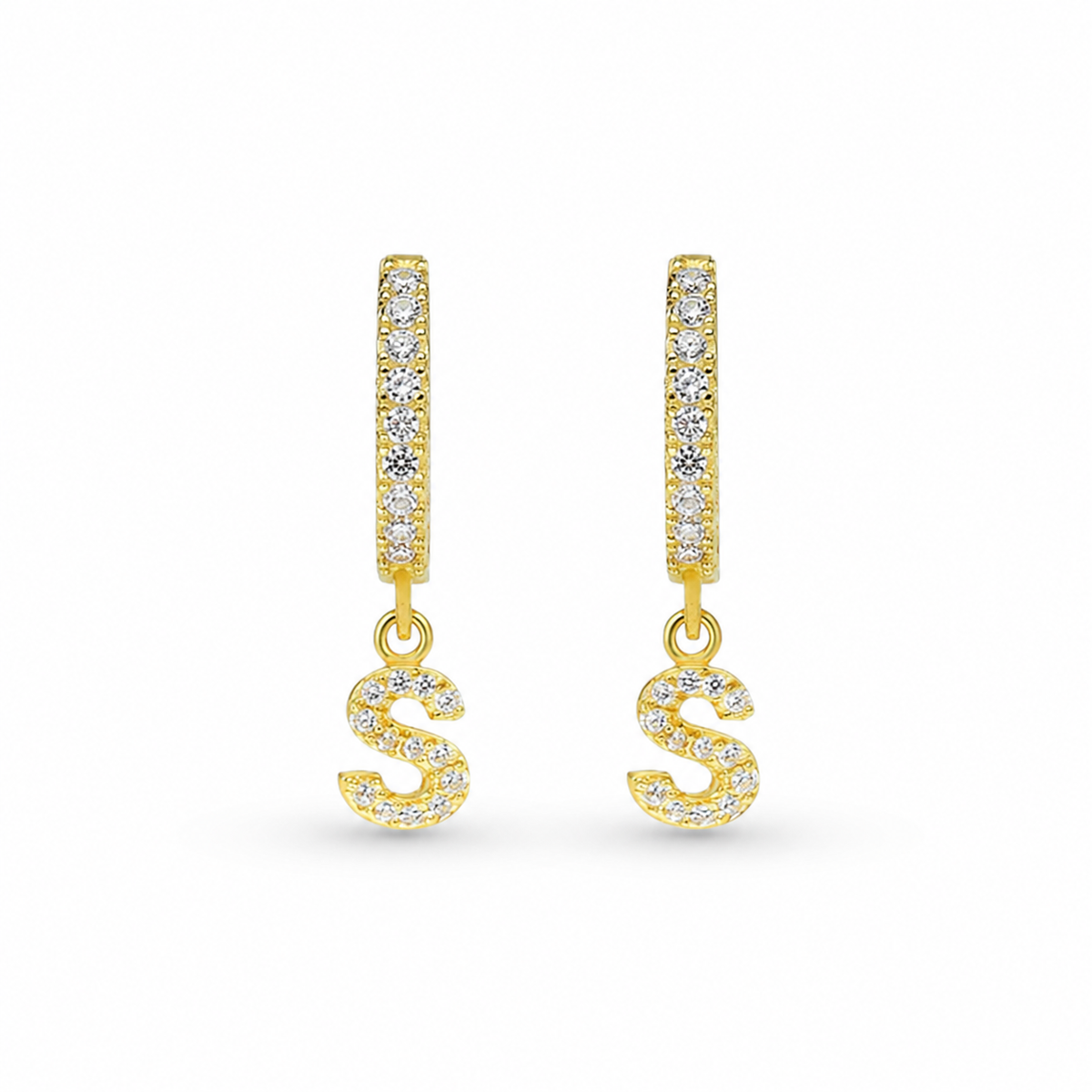 Gold-tone personalized CZ initial huggie earrings with a slim drop design and clear stone accents.