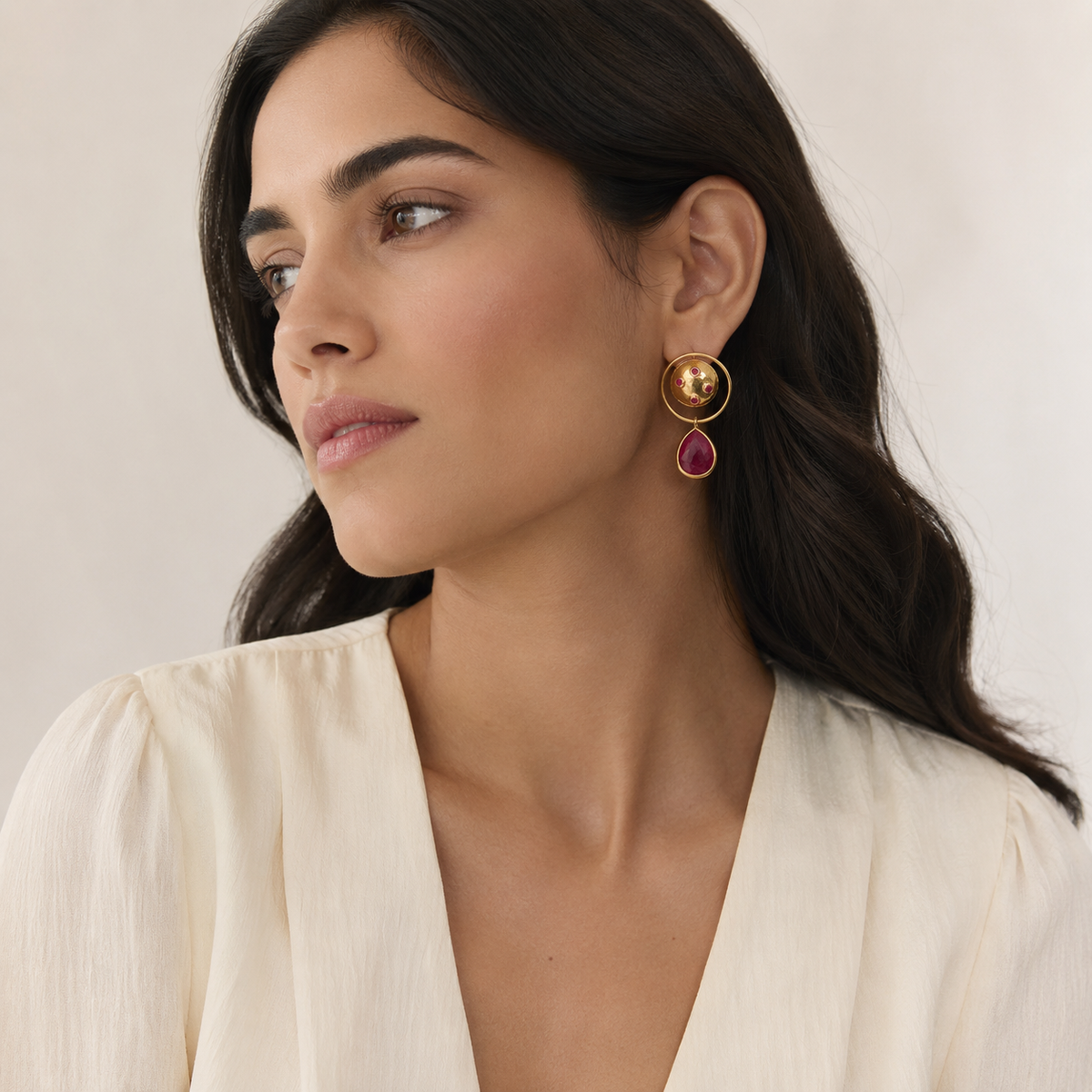 Gold-plated dangle earrings with a circular top, magenta accents, and a teardrop drop.