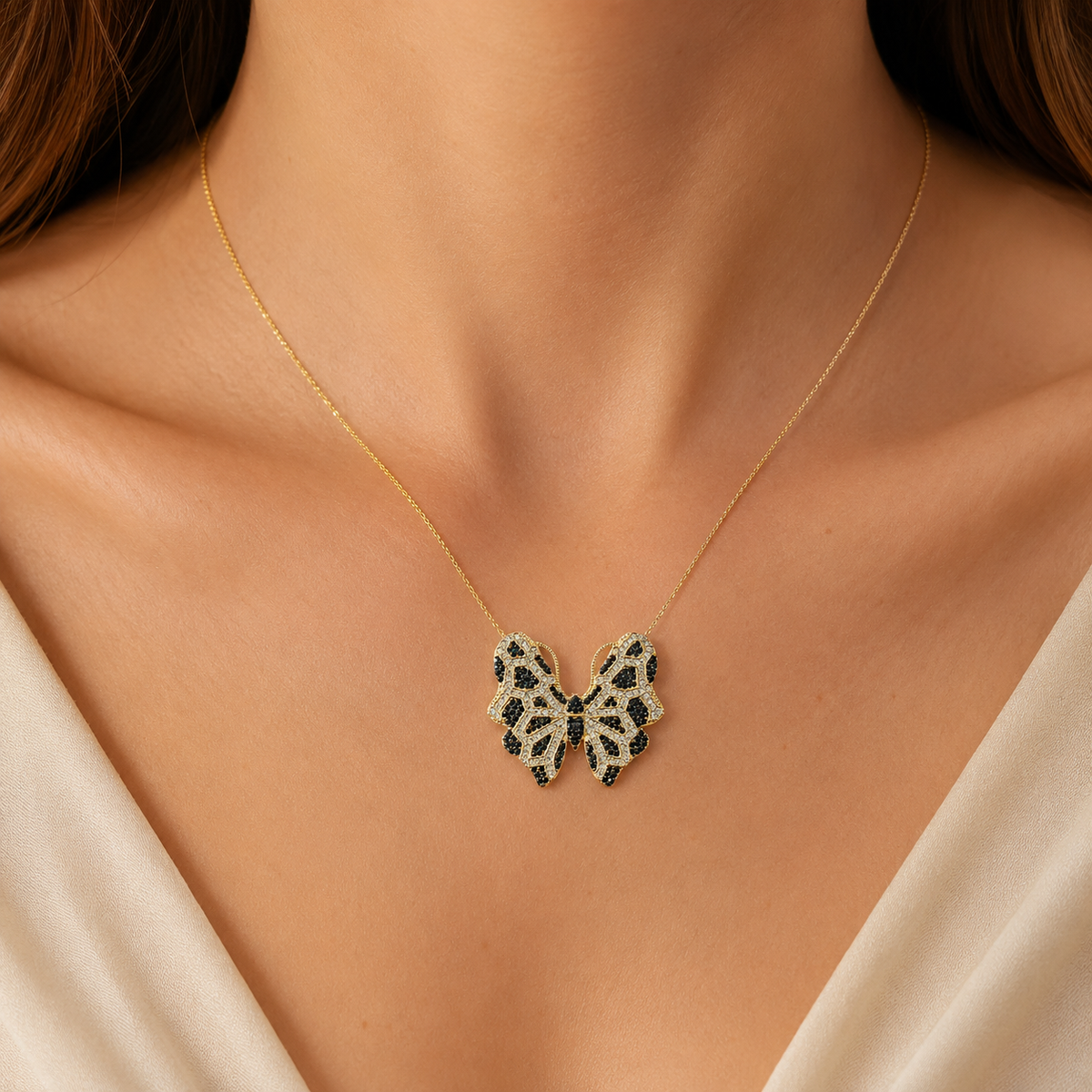 Gold-tone butterfly pendant necklace with multicolor CZ accents shown on a white background.