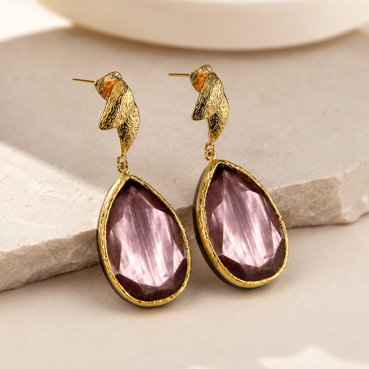 Purple tulip-inspired drop earrings shown at an angle with a gold-plated finish and faceted drop shape.
