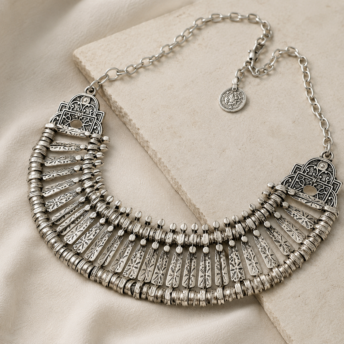 Angled view of a silver-tone fan collar statement necklace