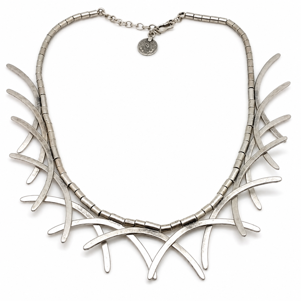 Silver-tone abstract branch collar necklace with a sculptural curved silhouette.