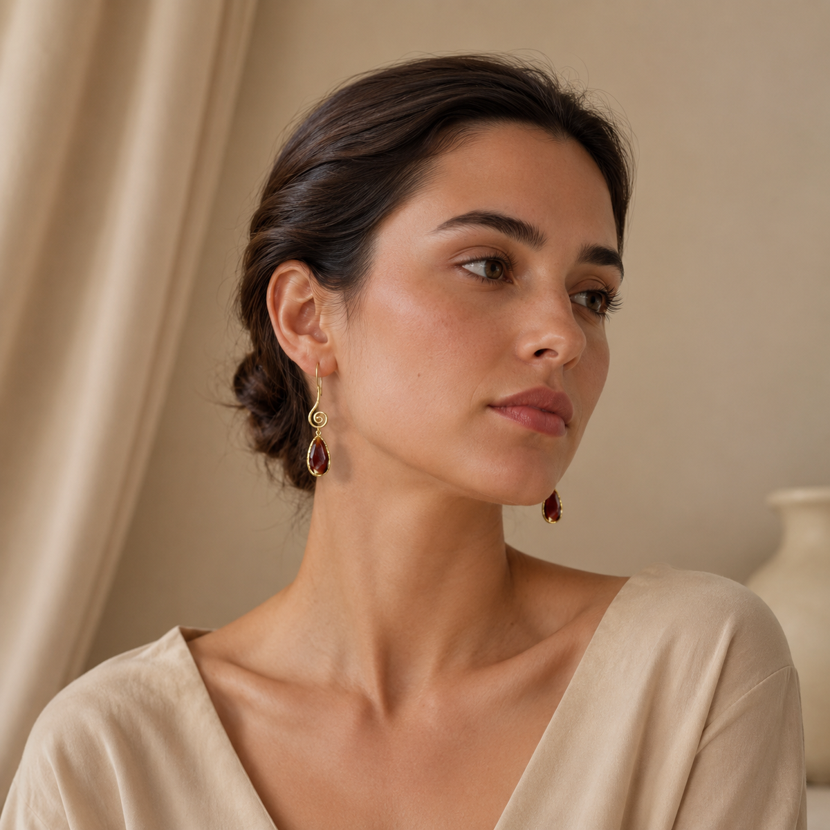Gold-plated spiral earrings with brown teardrop drops.