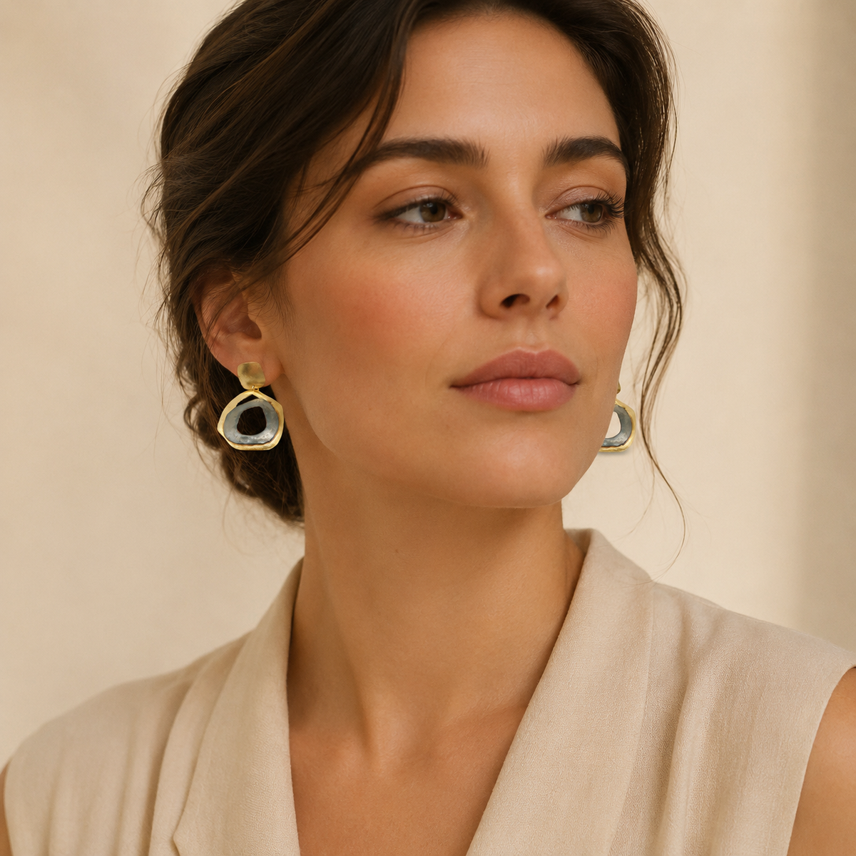 Pair of sculptural drop earrings with a modern abstract circle shape.