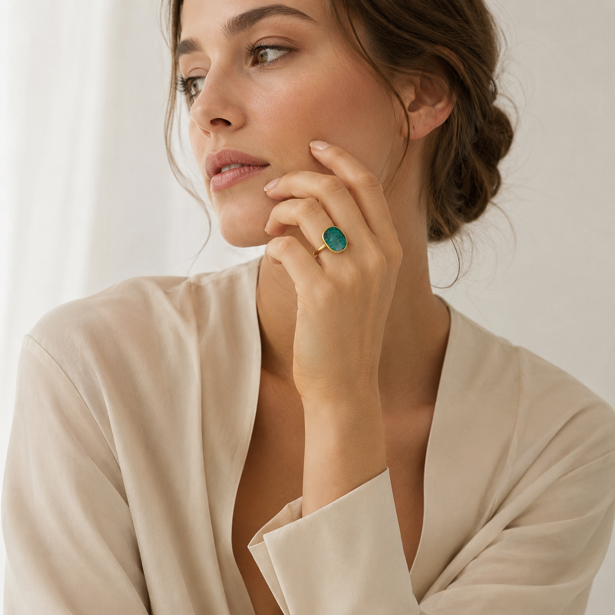 Bold emerald green statement ring with a smooth gold finish.