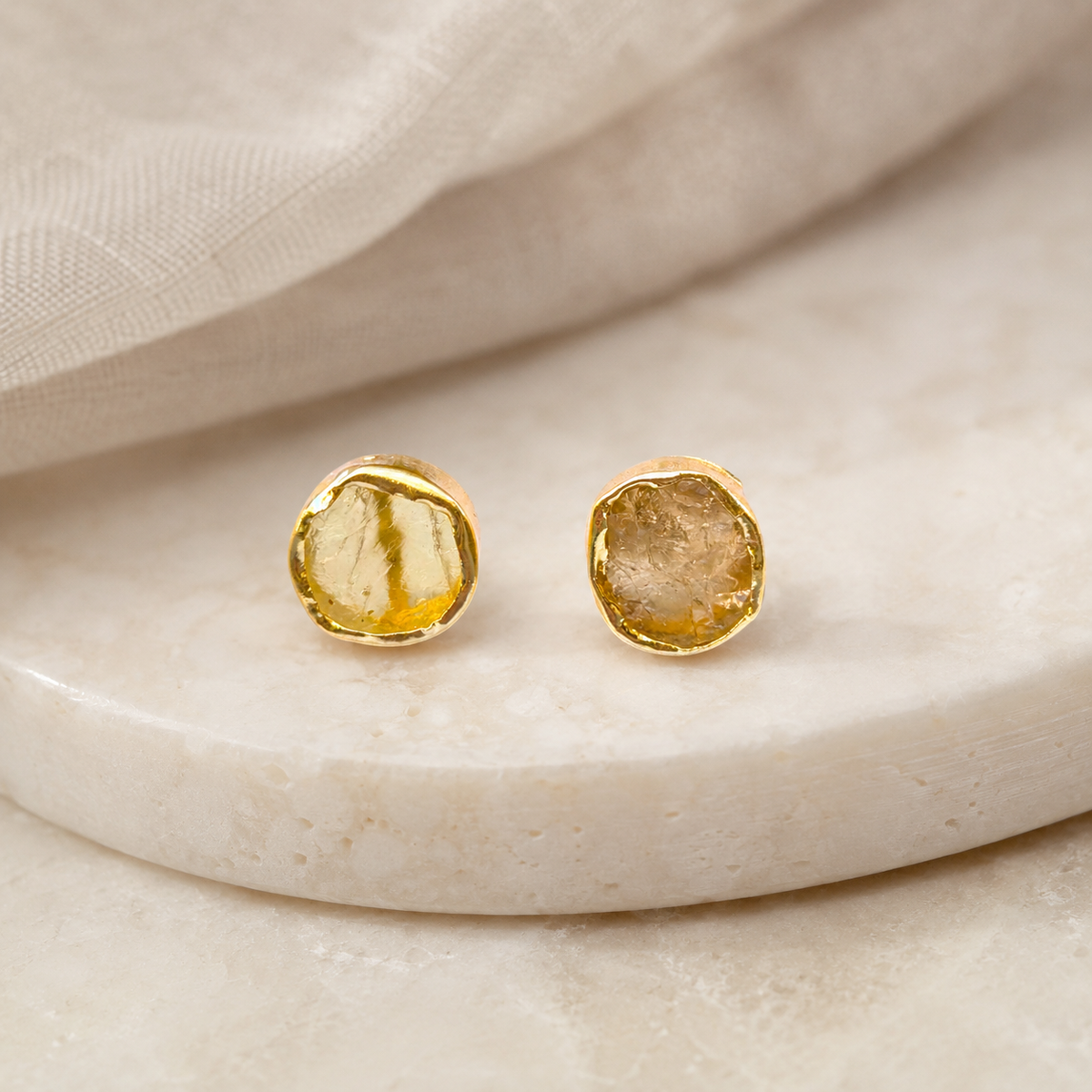 Gold-tone stud earrings with rough citrine stones.