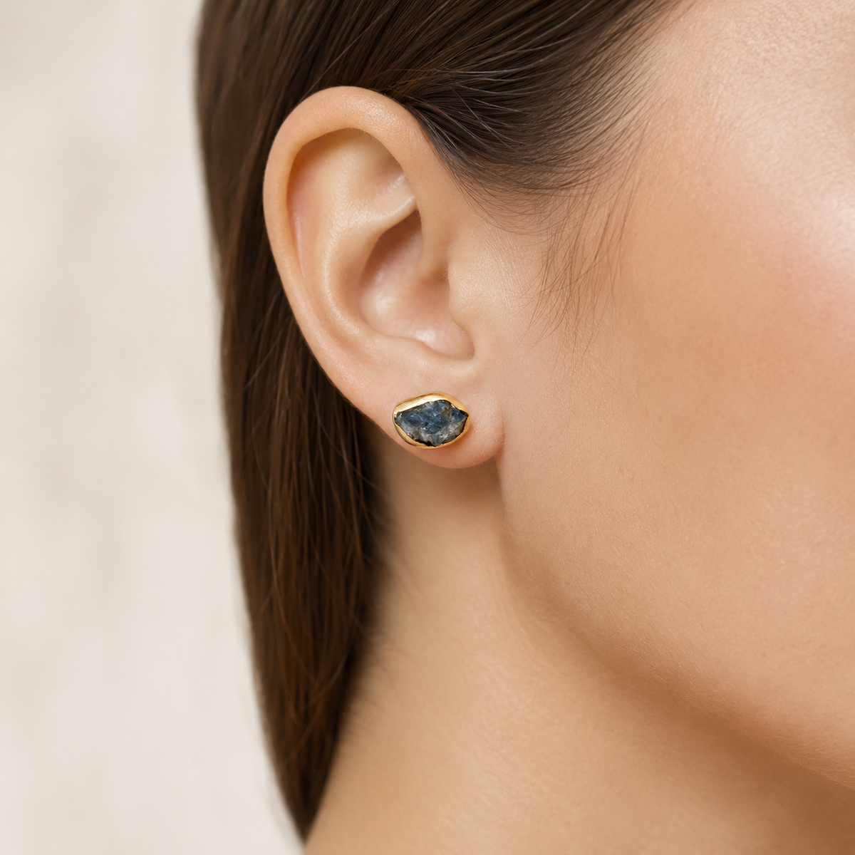 Gold-plated heart stud earrings shown from a close angle.