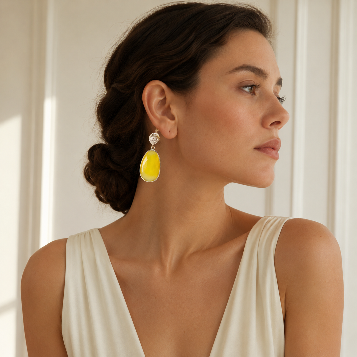 Pair of gold-tone drop earrings with a shell-textured top and yellow faceted stone detail.