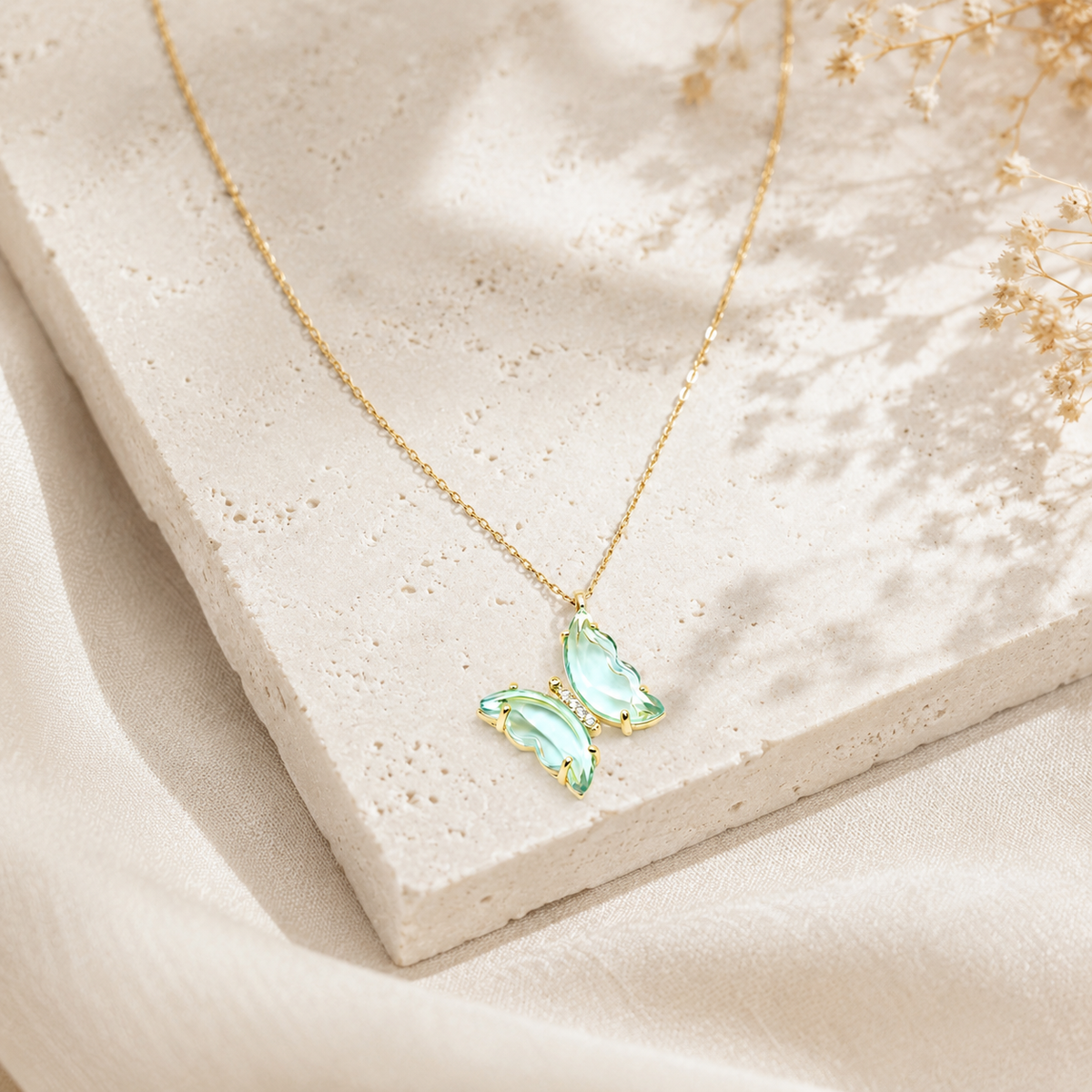 Light blue butterfly necklace with a delicate gold-tone chain.