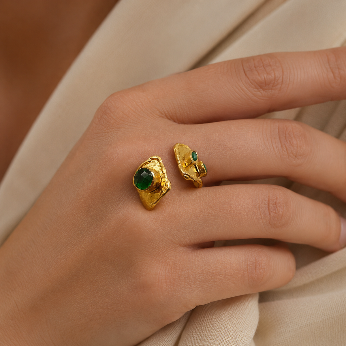 Gold-plated open cuff ring shown from a different angle with emerald green stone accents.
