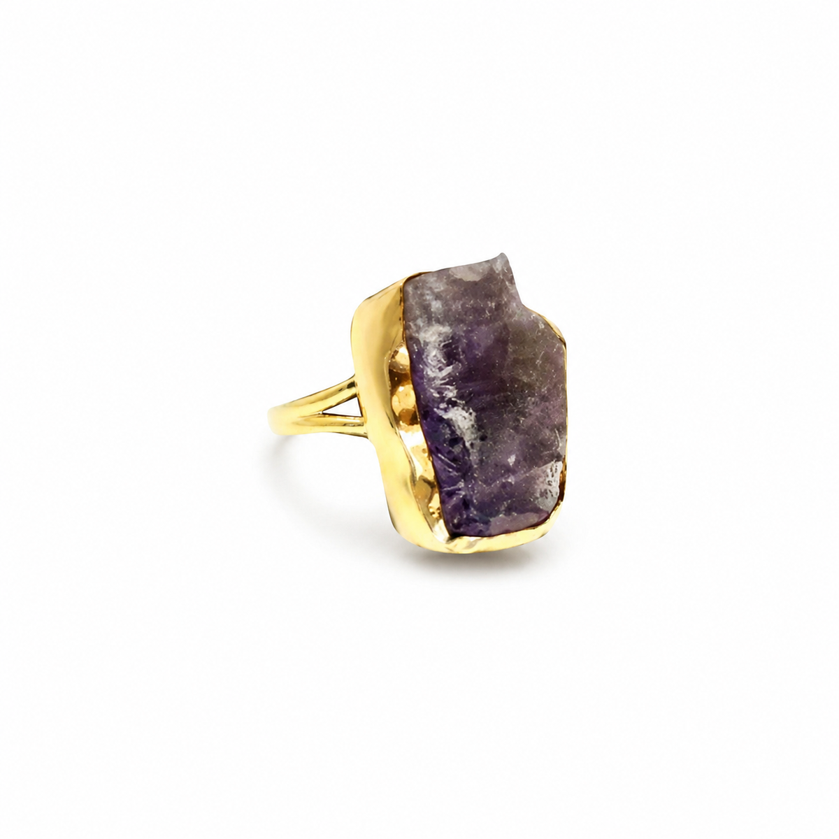 Raw amethyst statement ring with a gold-plated setting on a white background.