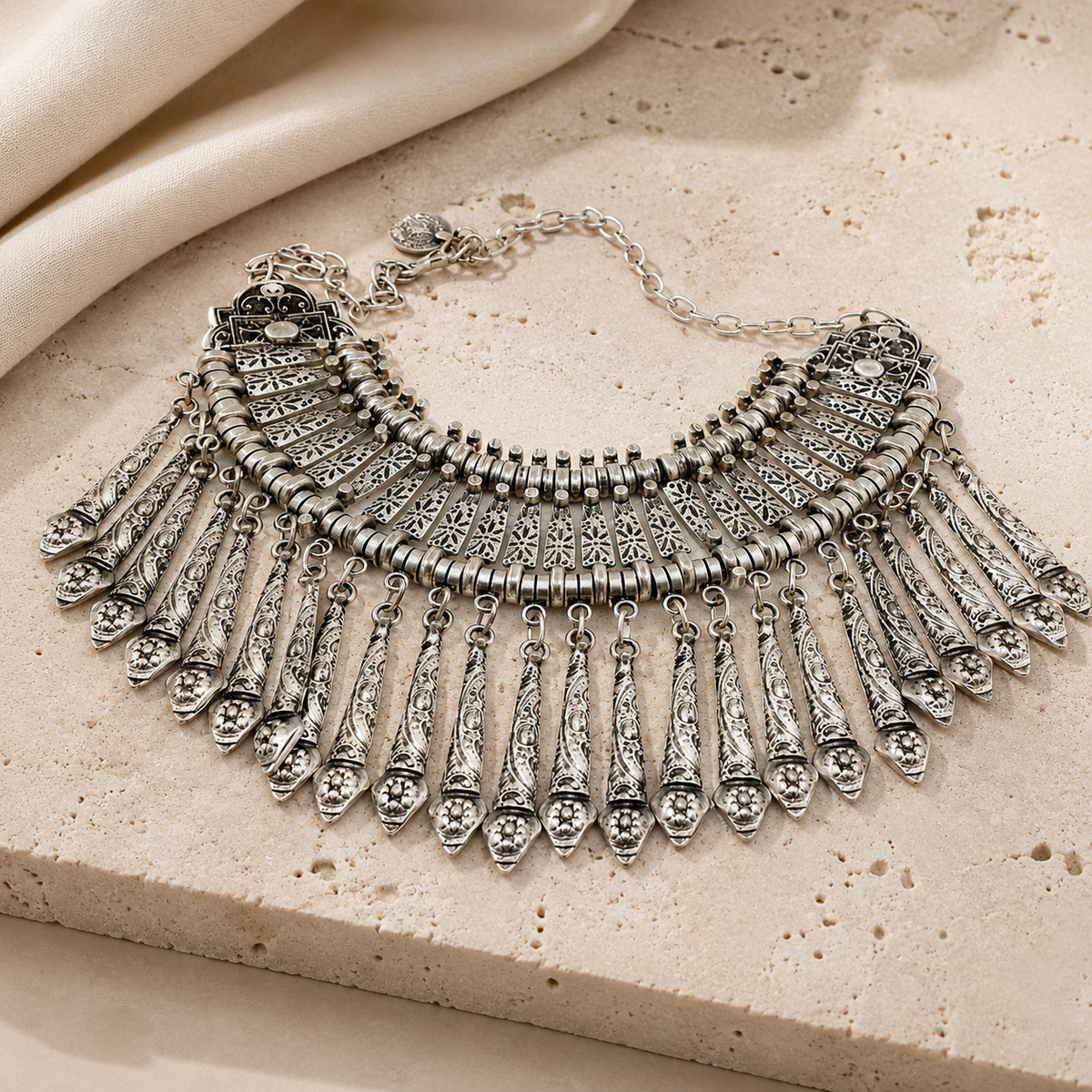 Silver-tone boho collar necklace with layered fringe and a bold textured silhouette.